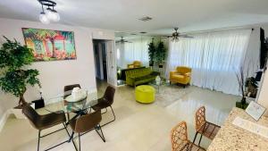 a living room with a glass table and chairs at Cozy Comfy House in Pembroke Pines