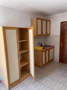 a kitchen with a door open to a kitchen with a sink at Apartments Top of Budva in Budva