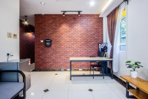 a room with a brick wall and a table at Surprised Homestay Butterworth in Butterworth