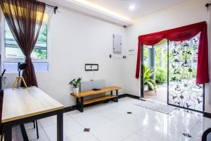 a room with a desk and a table and a door at Surprised Homestay Butterworth in Butterworth