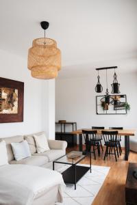 a living room with a couch and a table at Sunny and modern apartment ideal for groups in Barcelona