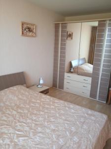 a bedroom with a bed and a dresser and a mirror at Nessebar, Apartment,South Beach, Larisa, in Nesebar