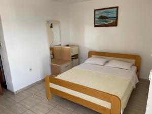 a small bedroom with a bed in a room at Apartments Top of Budva in Budva