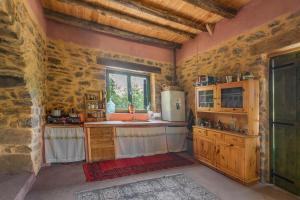a kitchen with a sink and a refrigerator at Hani Kastania - Chania retreat for families and groups for holidays and workshops in Sémbronas