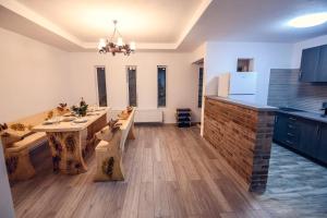 a large kitchen with a table and a counter top at Cabana Zabet in Ranca +7 photos