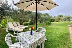 a table with an umbrella sitting on top of it at La Fornace Di Racciano in San Gimignano