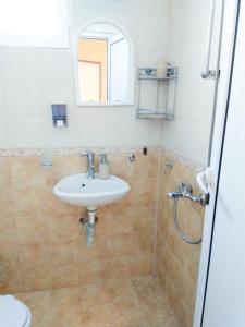 a bathroom with a sink and a shower at Kъща за гости Прохлада 3 и 4 етаж in Sinemorets +19 photos