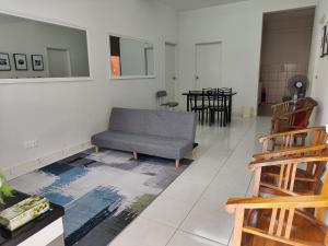 a living room with a couch and a table at Zaara Homestay Krubong Alor Gajah Ayer Keroh Melaka in Malacca