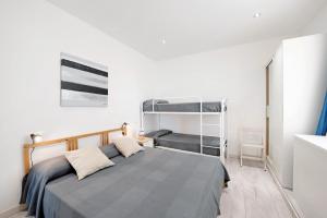 a bedroom with a bed and a bunk bed at Bilocale Mezzano in centro in Varazze +12 photos