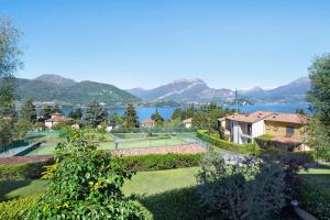um resort com um campo de ténis e um lago em Residence I Prati di Giussana em Lierna