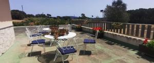 a patio with chairs and tables on a balcony at Can Salgas in Montrás