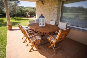 a wooden table and chairs on a patio at Can Salgas in Montrás