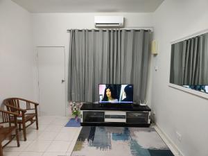 a living room with a flat screen tv on a table at Zaara Homestay Krubong Alor Gajah Ayer Keroh Melaka in Malacca