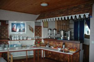 a kitchen with a sink and a counter top at Hôtel L'Ecrin in La Plaine des Cafres