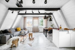 a living room and kitchen with a couch and a table at Aspen - Domek w Korbielowie in Korbielów