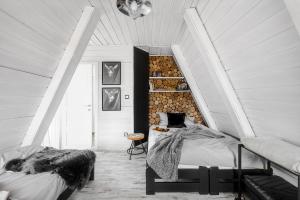 a bedroom with two beds and a stair case at Aspen - Domek w Korbielowie in Korbielów