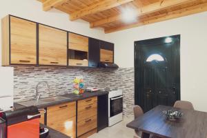 una cucina con armadi in legno e una porta nera di Burnelia Vacation House a Lefkimmi Altre 19 foto