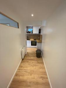 a hallway with a stairway with a kitchen in a house at Le typique touquetois, 55m² hypercentre in Le Touquet-Paris-Plage +3 photos
