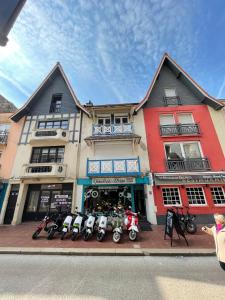a building with motorcycles parked in front of it at Le typique touquetois, 55m² hypercentre in Le Touquet-Paris-Plage