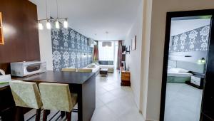 cocina y sala de estar con mesa y sillas en Briz Beach Apartments en Sunny Beach