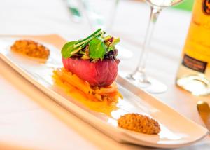 a plate of food with vegetables on a table at Coul House Hotel in Contin