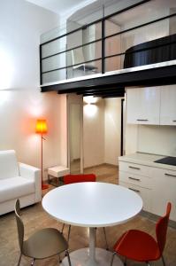 a living room with a white table and chairs at BB Hotels Aparthotel Bocconi in Milan