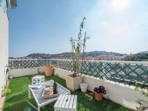 a balcony with a table and chairs on a roof at Apartment Turquoise-8 by Interhome in Cavalaire-sur-Mer