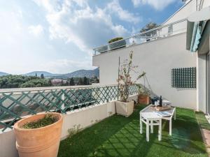 a small balcony with a table and chairs on top of a building at Apartment Turquoise-8 by Interhome in Cavalaire-sur-Mer