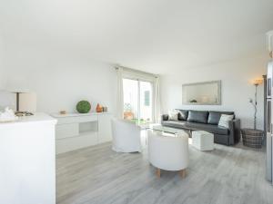 a white living room with a couch and a table at Apartment Turquoise-8 by Interhome in Cavalaire-sur-Mer