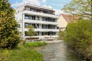 a building with a river in front of it at Apartment 3 in Rielasingen-Worblingen