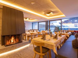 a restaurant with tables and a fireplace at Apartment Emma Deluxe Aparthotel-14 by Interhome in Fürth