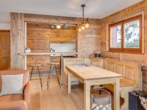 a kitchen in a log cabin with a table and chairs at Apartment Cérémonia 1 by Interhome in Villars-sur-Ollon