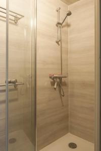 a shower with a glass door in a bathroom at Front room in Villa near Centre and TUe in Eindhoven