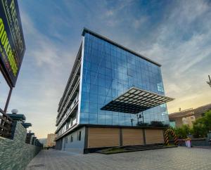 a large glass building with a reflection of the sky at SILVER REGENCY in Guwahati