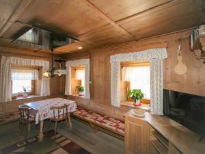 a dining room with a table and chairs and windows at Holiday Home Lamplberg by Interhome in Hippach +32 photos