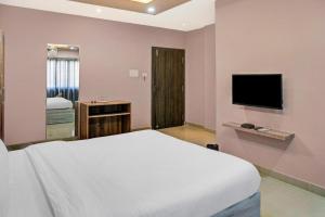 a bedroom with a bed and a flat screen tv at SILVER REGENCY in Guwahati