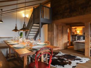 a dining room table with plates and glasses on it at Chalet Chalet Pierre Fleur by Interhome in Gryon