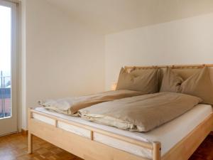a bed sitting in a room with a window at Holiday Home Terry by Interhome in Olivone