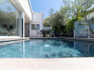 a swimming pool in front of a house at Holiday Home Pitágoras by Interhome in Roses