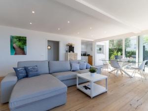 a living room with a blue couch and a table at Holiday Home Pitágoras by Interhome in Roses