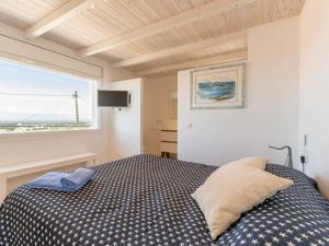 a bedroom with a bed and a large window at Holiday Home Pitágoras by Interhome in Roses