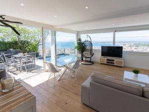 a living room with a couch and a table with chairs at Holiday Home Pitágoras by Interhome in Roses +33 photos