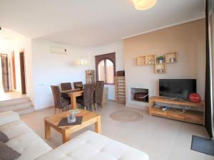 A television and/or entertainment centre at Holiday Home Flor de Ponoig by Interhome