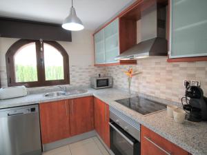 A kitchen or kitchenette at Holiday Home Flor de Ponoig by Interhome