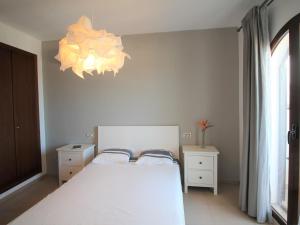 A bed or beds in a room at Holiday Home Flor de Ponoig by Interhome