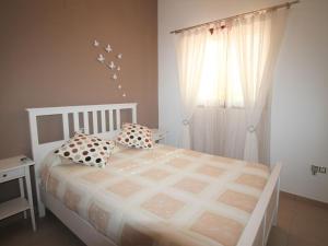 A bed or beds in a room at Holiday Home Flor de Ponoig by Interhome