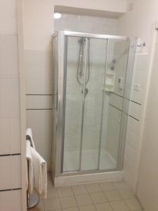 a shower with a glass door in a bathroom at Mare Nostrum Petit Hôtel in Pozzallo