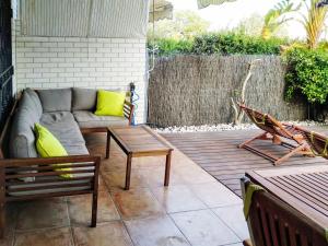 a patio with a couch and a table and a bench at Apartment Vila del Far by Interhome in Sant Carles de la Ràpita +9 photos