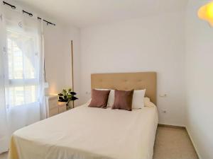 a bedroom with a large white bed with pillows at Apartment Bitacoras by Interhome in La Venteta