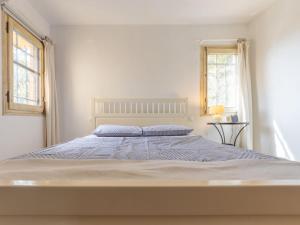 Säng eller sängar i ett rum på Holiday Home Rossi by Interhome